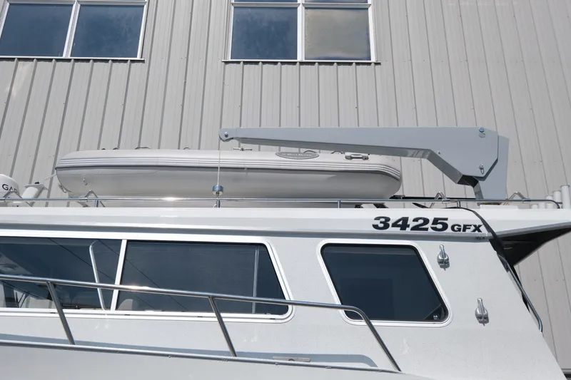 Slide: The Image of 2022 KingFisher 3425 GFX Offshore boat with mounted dinghy and crane. - 3