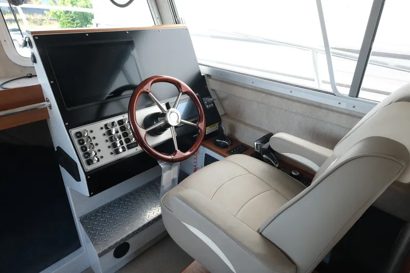 Slide: The Image of Helm of 2022 KingFisher 3425 GFX Offshore boat with steering wheel and control panel. - 11