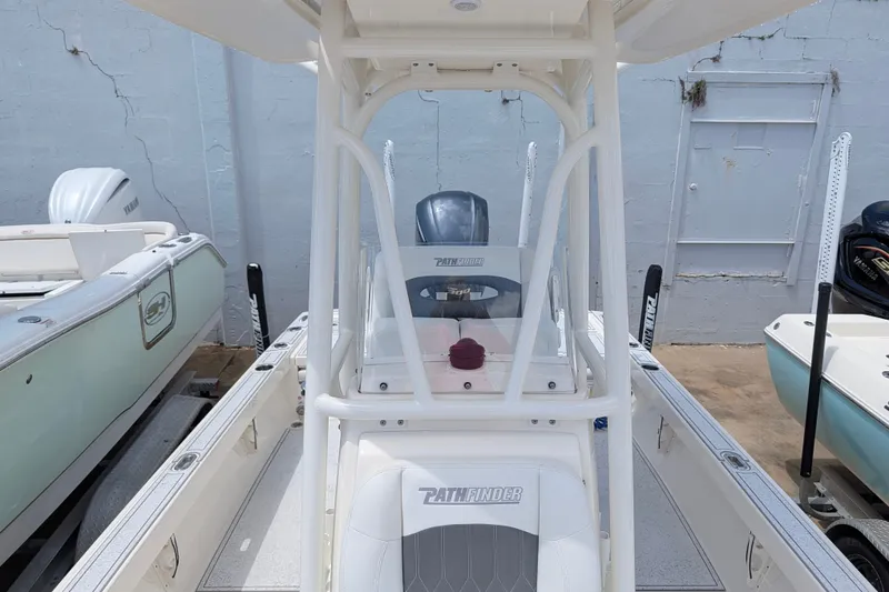 Slide: The Image of 2021 Pathfinder 2500 Hybrid boat, center console view, parked between other boats. - 49