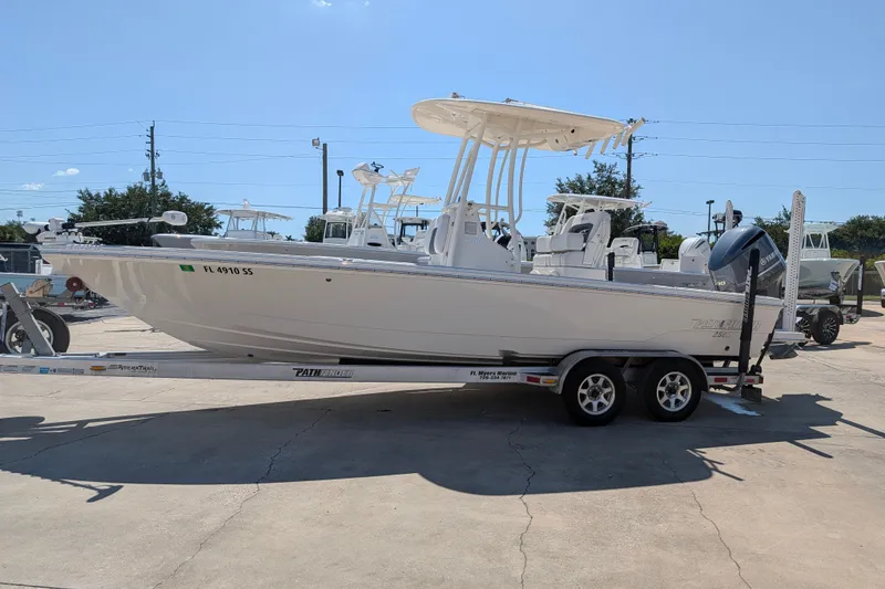Slide: The Image of 2021 Pathfinder 2500 Hybrid boat on trailer in sunny outdoor setting. - 1