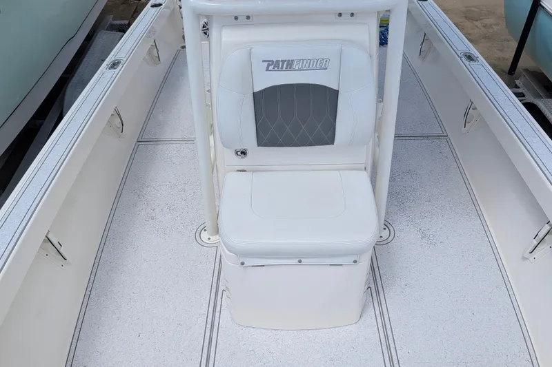 Slide: The Image of 2021 Pathfinder 2500 Hybrid boat interior with white seating and deck. - 47