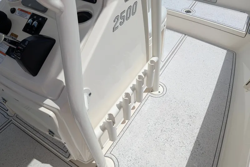 Slide: The Image of Pathfinder 2500 Hybrid boat interior, showcasing control panel and rod holders, 2021 model. - 36