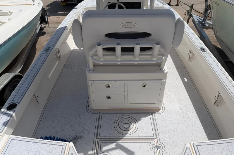 Slide: The Image of 2021 Pathfinder 2500 Hybrid boat interior with rod holders and storage compartments. - 20
