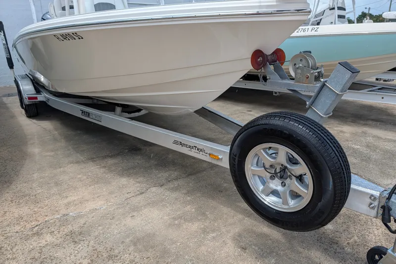 Slide: The Image of 2021 Pathfinder 2500 Hybrid boat on trailer, parked on concrete surface. - 8