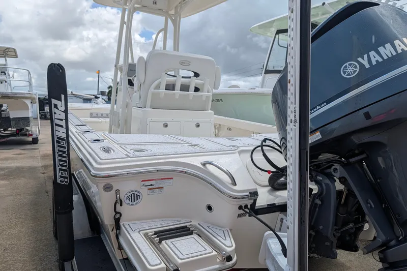 Slide: The Image of 2021 Pathfinder 2500 Hybrid boat with Yamaha engine, docked under cloudy skies. - 12