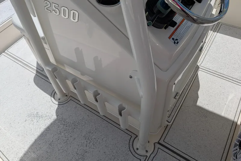 Slide: The Image of Pathfinder 2500 Hybrid 2021 boat console with rod holders and steering wheel. - 34