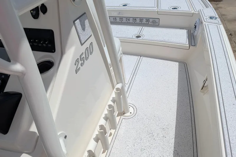 Slide: The Image of 2021 Pathfinder 2500 Hybrid boat interior with sleek white deck and control panel. - 37