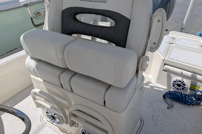 Slide: The Image of Captain's seat on a 2021 Pathfinder 2500 Hybrid boat, featuring cushioned armrests. - 27