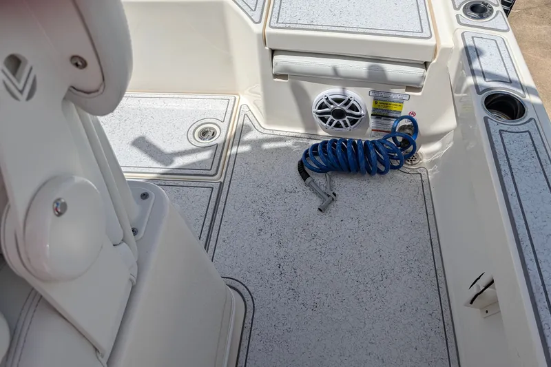 Slide: The Image of Interior of 2021 Pathfinder 2500 Hybrid boat with coiled blue hose and speaker. - 26