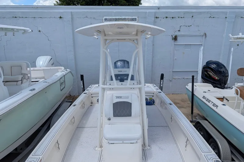 Slide: The Image of 2021 Pathfinder 2500 Hybrid boat in a storage area, surrounded by other boats. - 45