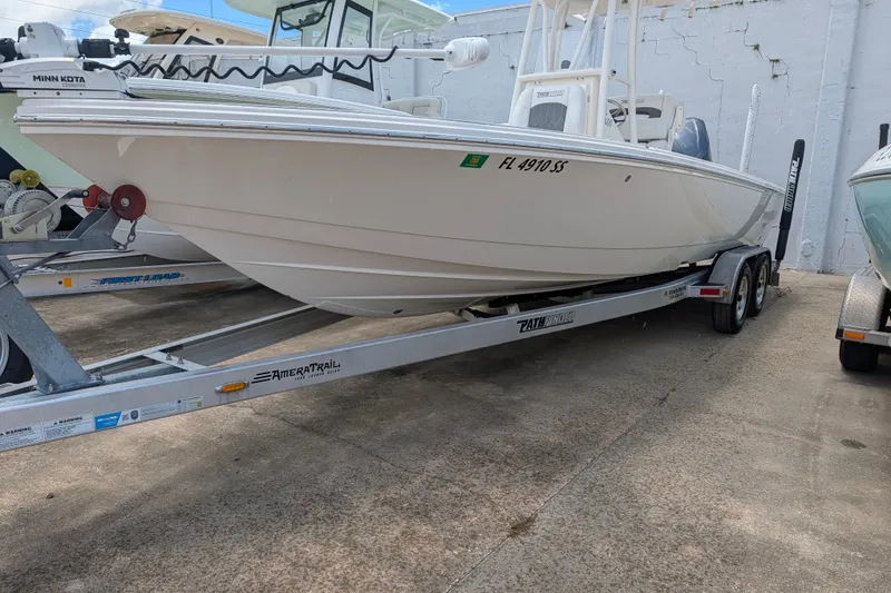 Slide: The Image of 2021 Pathfinder 2500 Hybrid boat on trailer, parked outdoors. - 9