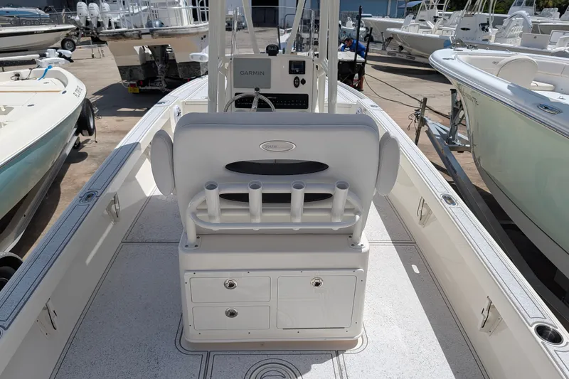 Slide: The Image of 2021 Pathfinder 2500 Hybrid boat interior with seating and storage, docked among other boats. - 22