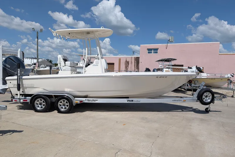 Slide: The Image of 2021 Pathfinder 2500 Hybrid boat on trailer under clear blue sky. - 2