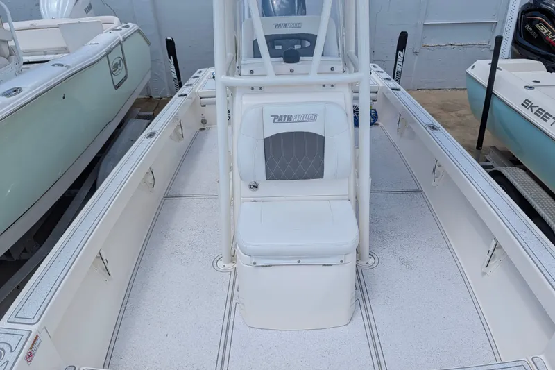 Slide: The Image of 2021 Pathfinder 2500 Hybrid boat interior with white seating and center console. - 40