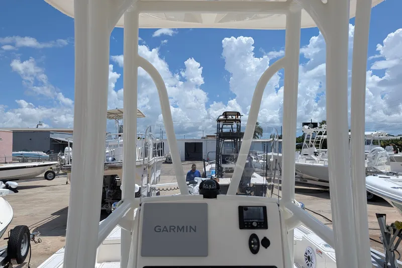 Slide: The Image of Pathfinder 2500 Hybrid boat dashboard with Garmin system, docked under a bright blue sky. - 31