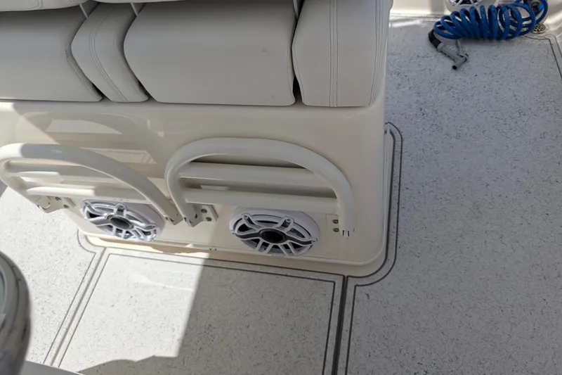 Slide: The Image of 2021 Pathfinder 2500 Hybrid boat interior with cushioned seating and built-in speakers. - 28