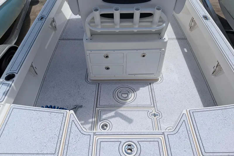 Slide: The Image of 2021 Pathfinder 2500 Hybrid boat interior with storage compartments and rod holders. - 19