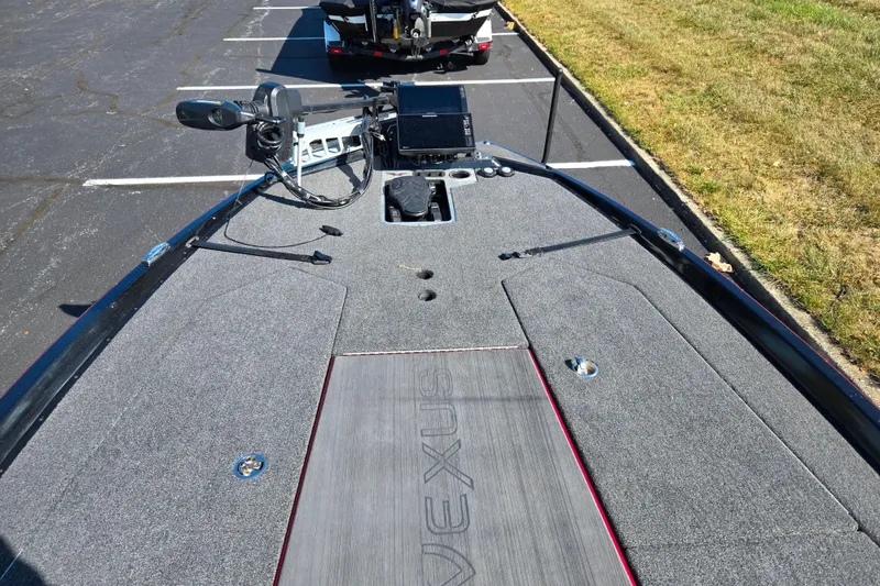 Slide: The Image of 2025 Vexus VX21 boat deck with advanced navigation equipment, parked on asphalt. - 19
