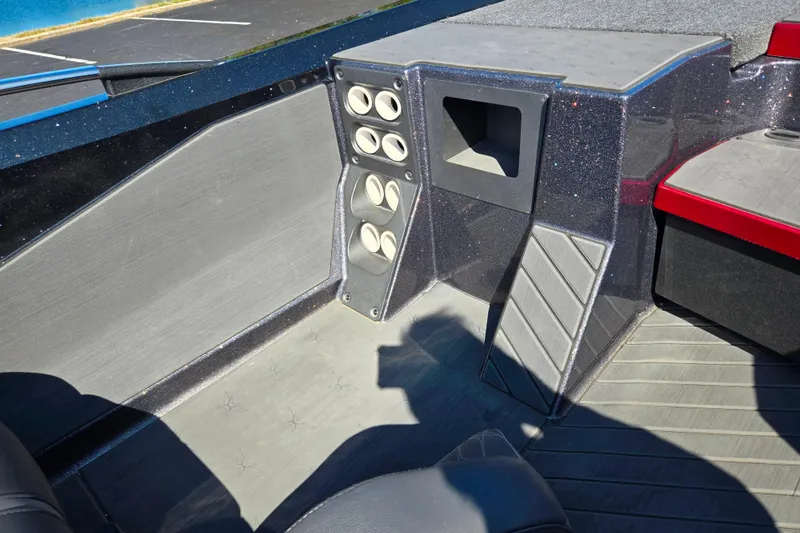 Slide: The Image of 2025 Vexus VX21 boat interior with cup holders and storage compartment. - 18