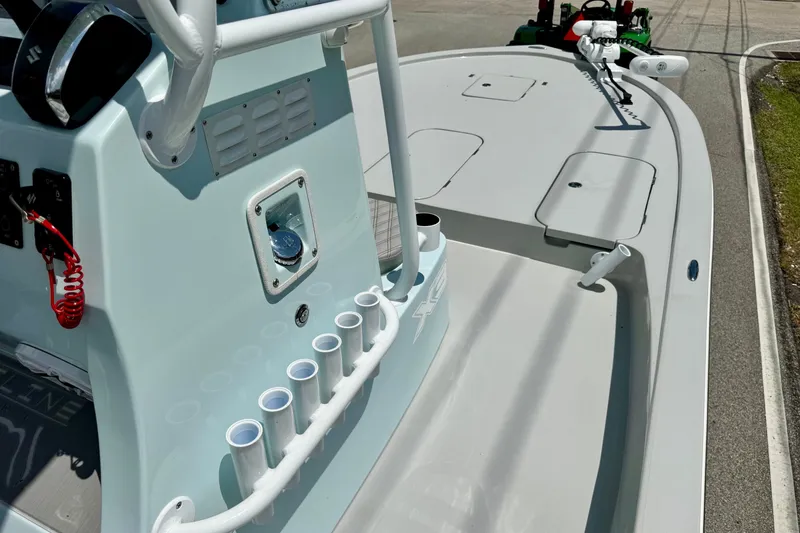 Slide: The Image of 2024 Shallow Sport 25 X3 boat deck with rod holders and control panel. - 16