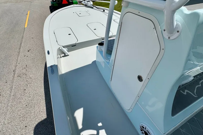 Slide: The Image of 2024 Shallow Sport 25 X3 boat interior, showcasing spacious deck and storage compartments. - 13