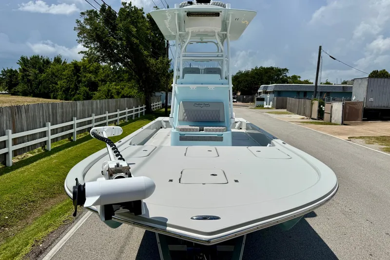 Slide: The Image of 2024 Shallow Sport 25 X3 boat on a road, showcasing sleek design and advanced features. - 6