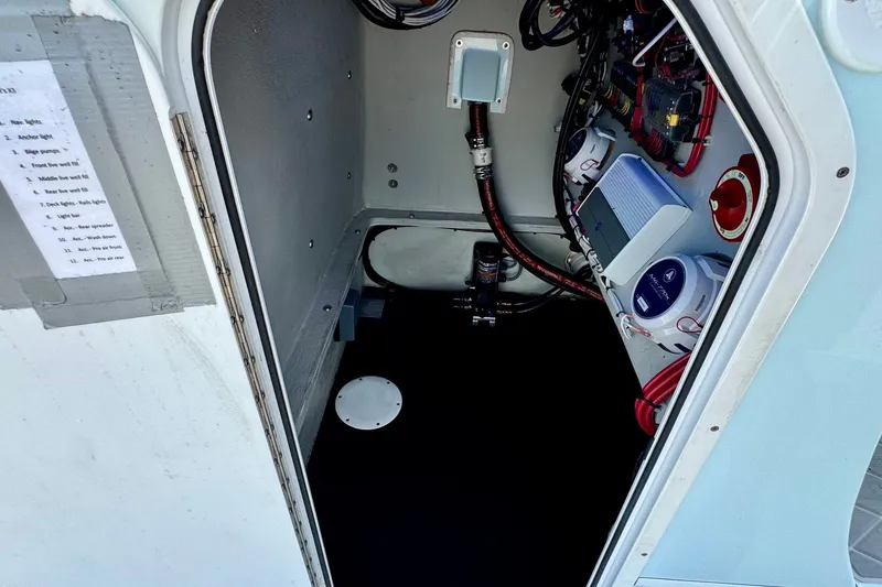 Slide: The Image of 2024 Shallow Sport 25 X3 boat interior wiring and equipment compartment. - 14