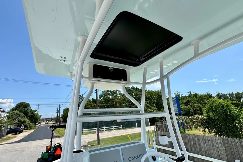 Slide: The Image of 2024 Shallow Sport 25 X3 boat console with Garmin electronics, under a clear blue sky. - 11