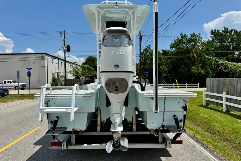 Slide: The Image of 2024 Shallow Sport 25 X3 boat with Suzuki 350 engine on trailer, street view. - 3