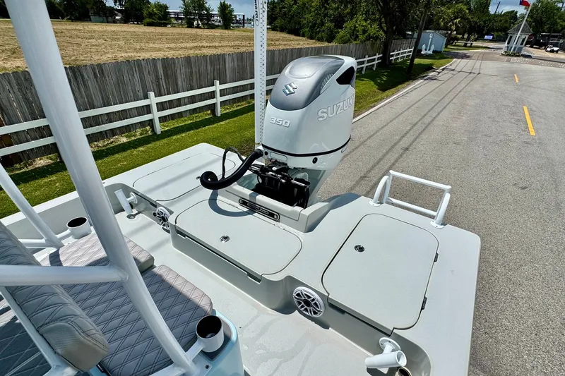 Slide: The Image of 2024 Shallow Sport 25 X3 boat with Suzuki 350 engine, parked on a road. - 7