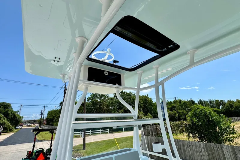 Slide: The Image of 2024 Shallow Sport 25 X3 boat with elevated helm station and clear blue sky. - 12