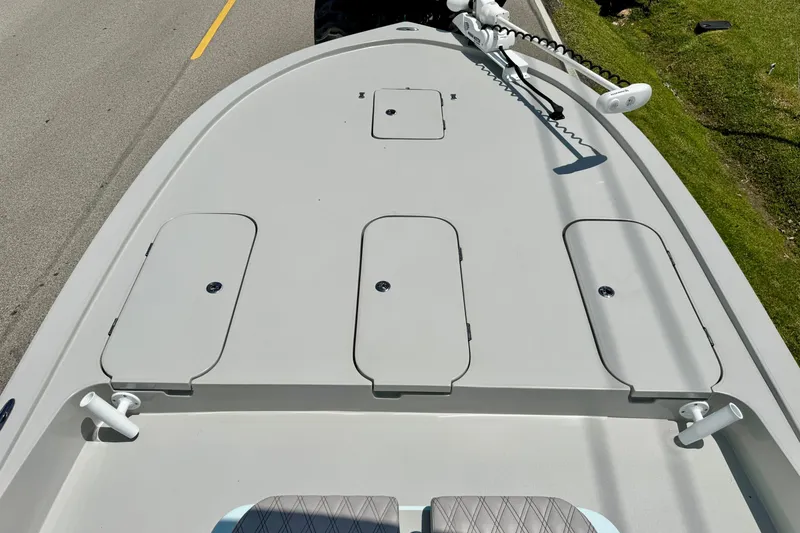 Slide: The Image of 2024 Shallow Sport 25 X3 boat deck with storage compartments and trolling motor. - 15