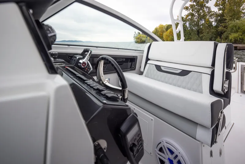Slide: The Image of 2024 Blackfin 272 DC boat interior with steering wheel and control panel. - 25
