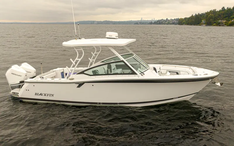 Slide: The Image of 2024 Blackfin 272 DC boat on water with twin Mercury engines. - 2