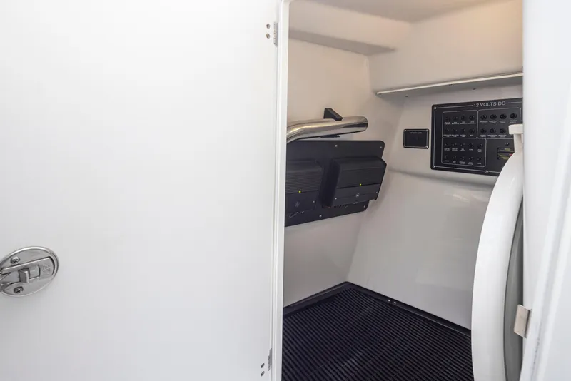 Slide: The Image of 2024 Blackfin 272 DC electrical panel and storage compartment. - 33