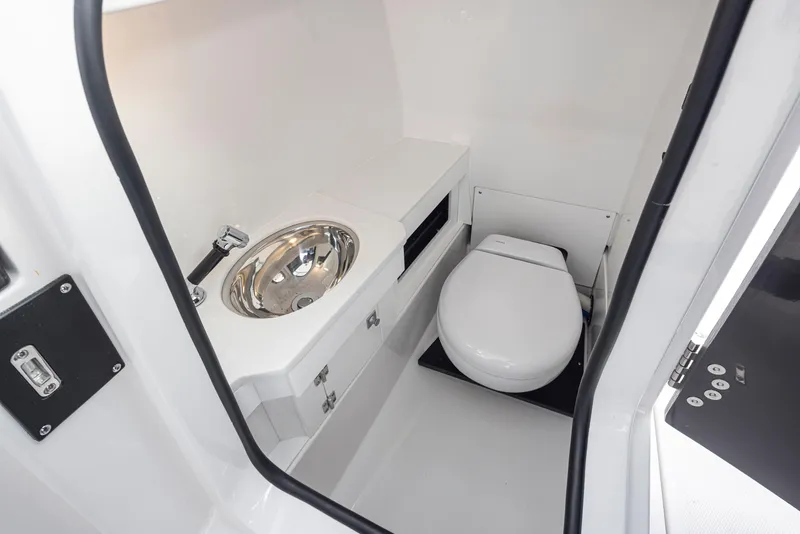 Slide: The Image of 2024 Blackfin 272 DC boat interior bathroom with sink and toilet. - 30
