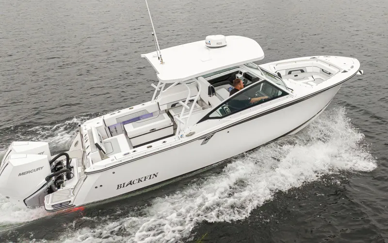 Slide: The Image of 2024 Blackfin 272 DC boat cruising on water, powered by Mercury engines. - 3