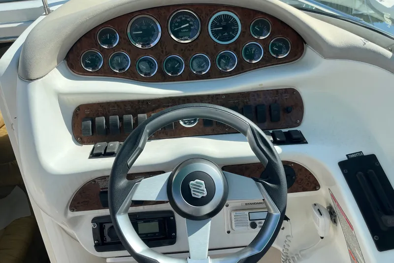 Slide: The Image of 1998 Sea Ray 280 Sun Sport dashboard with steering wheel and instrument panel. - 10