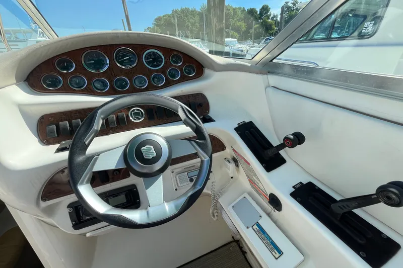 Slide: The Image of Cockpit of 1998 Sea Ray 280 Sun Sport with steering wheel and control panel. - 9