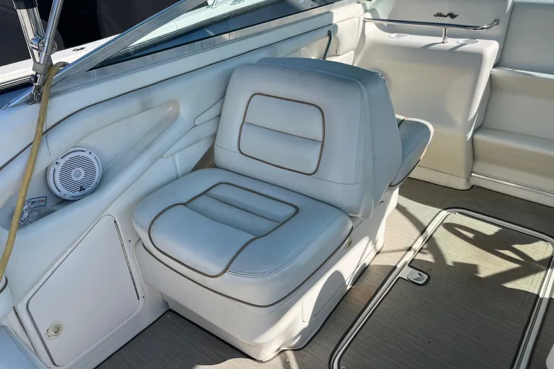 Slide: The Image of White leather seating on a 1998 Sea Ray 280 Sun Sport boat interior. - 13