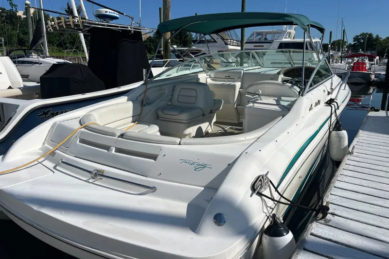 Slide: The Image of 1998 Sea Ray 280 Sun Sport boat docked at marina, featuring spacious seating and sleek design. - 2