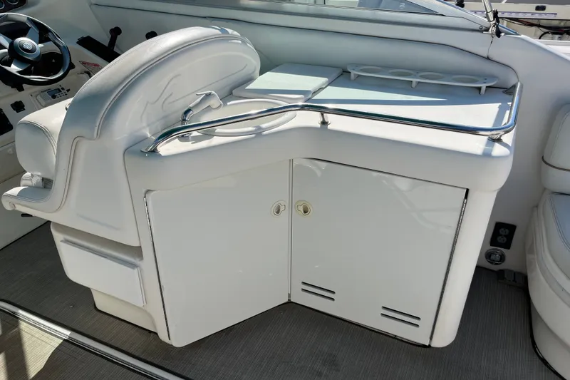 Slide: The Image of Interior of 1998 Sea Ray 280 Sun Sport boat with white seating and storage. - 11