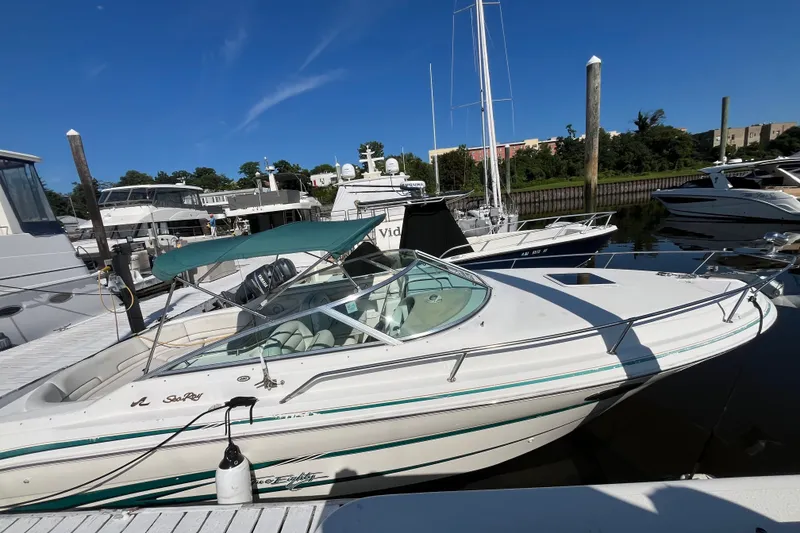 Slide: The Image of 1998 Sea Ray 280 Sun Sport boat docked at marina under clear blue sky. - 5