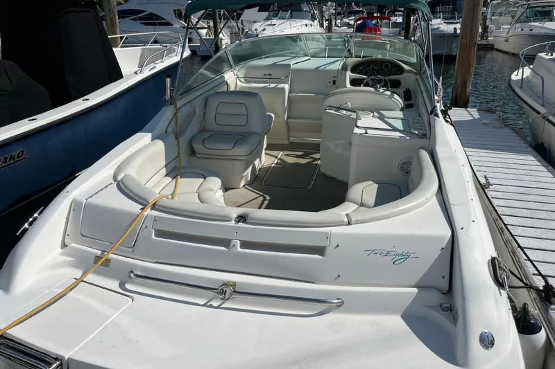 Slide: The Image of 1998 Sea Ray 280 Sun Sport boat docked, featuring spacious seating and sleek design. - 3
