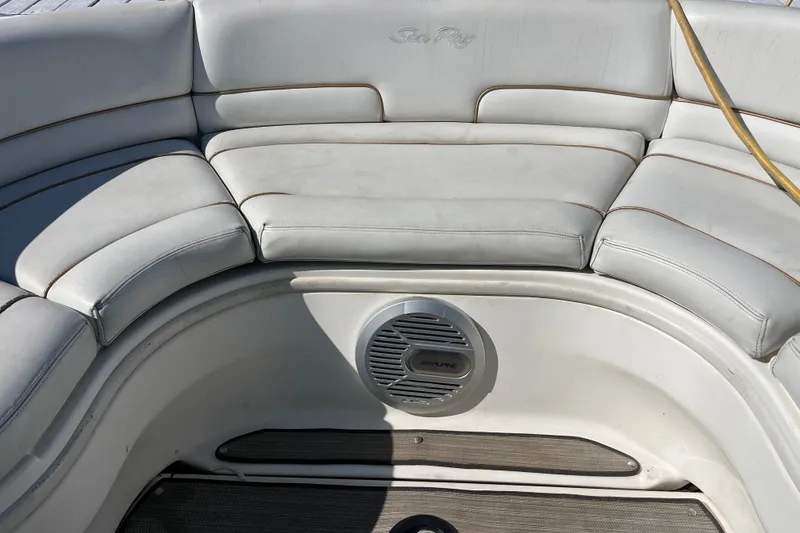 Slide: The Image of 1998 Sea Ray 280 Sun Sport boat interior with white cushioned seating and Alpine speaker. - 6