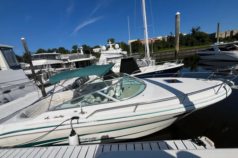 Slide: The Image of 1998 Sea Ray 280 Sun Sport docked at marina under clear blue sky. - 4