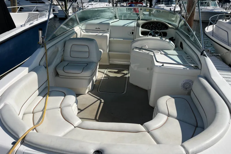 Slide: The Image of 1998 Sea Ray 280 Sun Sport boat interior with white seating and dashboard. - 7