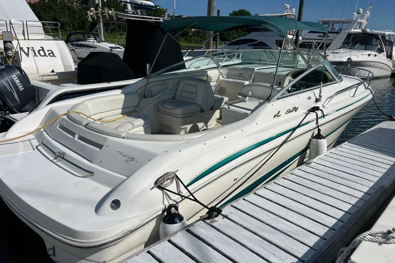 Slide: The Image of 1998 Sea Ray 280 Sun Sport docked, featuring sleek design and spacious seating. - 1