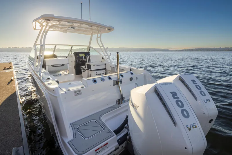 Slide: The Image of The 2027 Blackfin 252 DC is docked, featuring twin 200 HP engines and a spacious cockpit. - 32