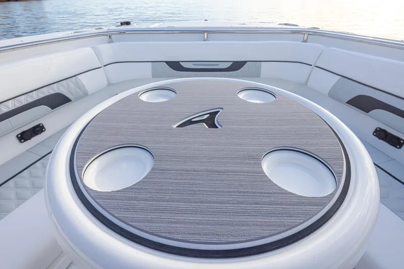 Slide: The Image of 2024 Blackfin 252 DC boat interior with circular table and cup holders. - 31
